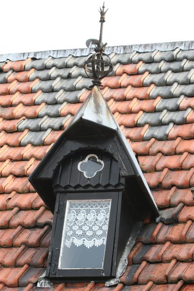 Beautiful little window ( dak raampje) with lace curtain.