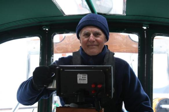 Bert in his winter clothes, gloves, hat, and a hot drink.