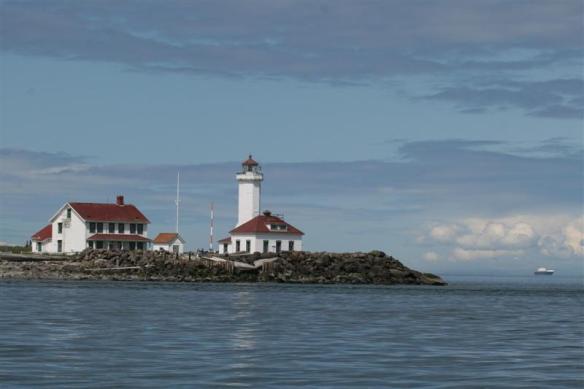 Going past Point Wilson, motoring into Juan de Fuca, with the one large freighter showing in the background.  