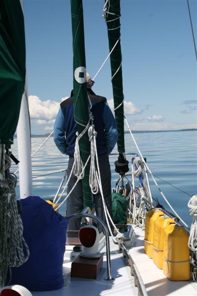 Skipper daydreaming at the bow.( probably wishing for wind...)