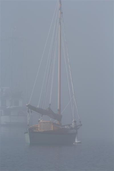 sailing vessel ' lucky ' , out  in the fog. 