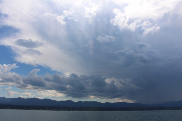 A thunderstorm, slowly forming above the mountain ridge.